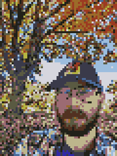 comically low-resolution image of Frank Wills wearing a Maryland baseball cap in front of an autumnal tree.